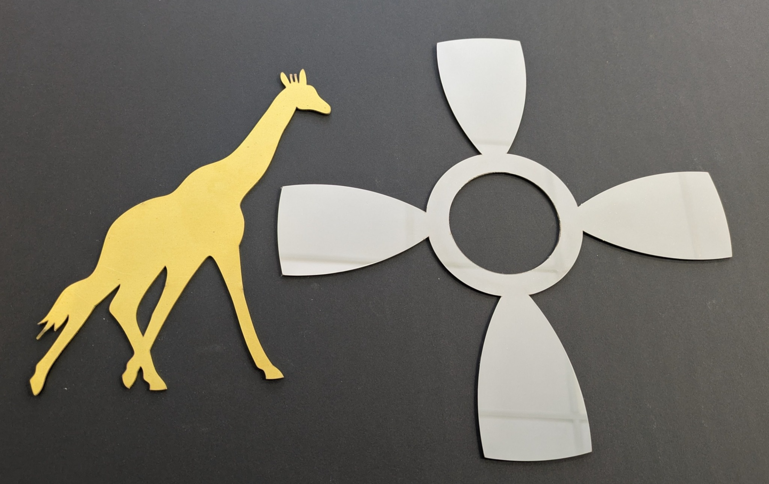 Brass giraffe and mirror stainless steel propellor laser cut from sheet metal